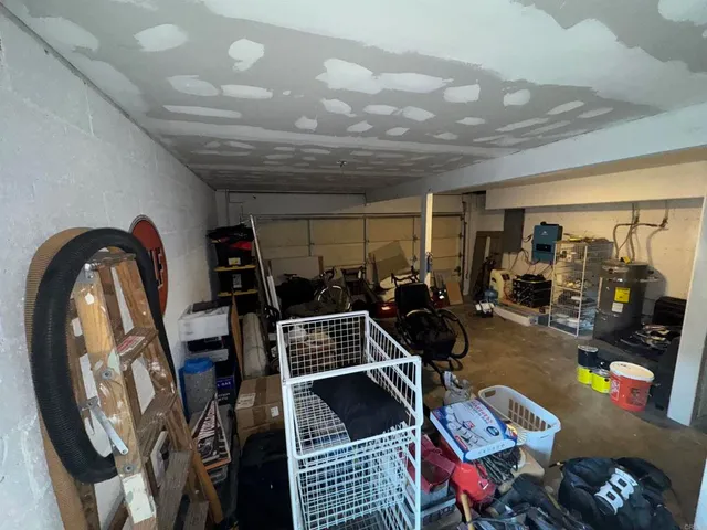 a backyard of a house with wooden floor barbeque oven and outdoor seating