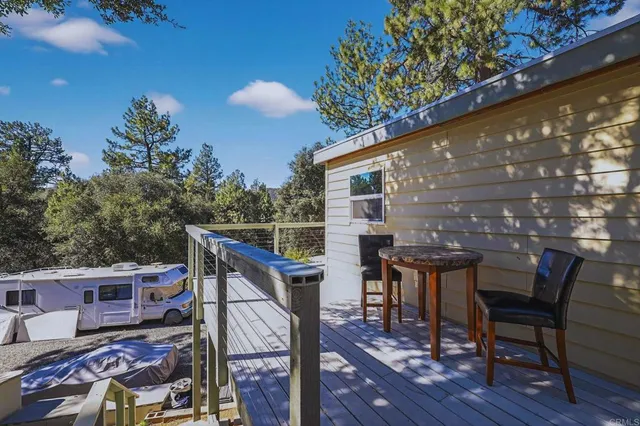 a view of a chairs and table on the deck