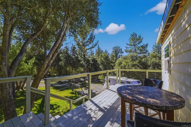 a view of deck with table and chairs and wooden floor