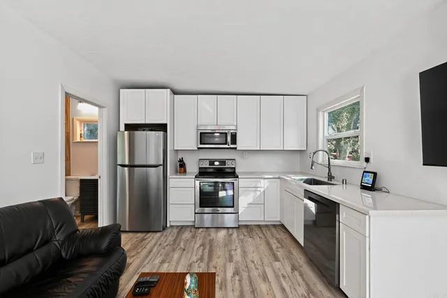 a kitchen with a refrigerator stove and sink