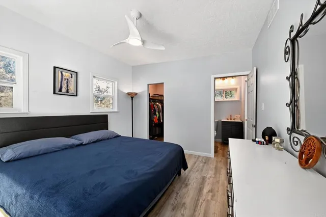 a bedroom with a bed and a dresser