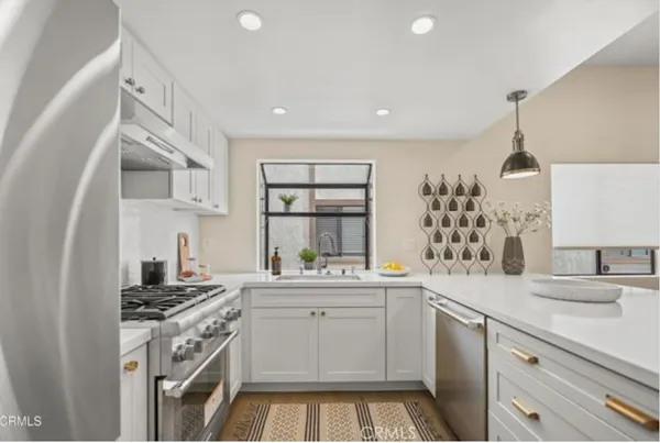 a kitchen with a sink stove and cabinets