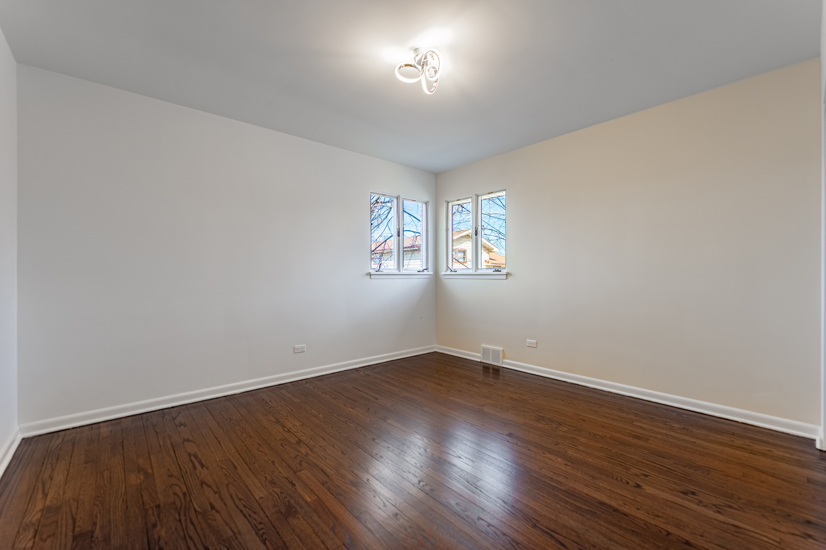 4313 Elm Avenue Lyons, IL 60534 - Photo 14 of 34 an empty room with wooden floor and windows