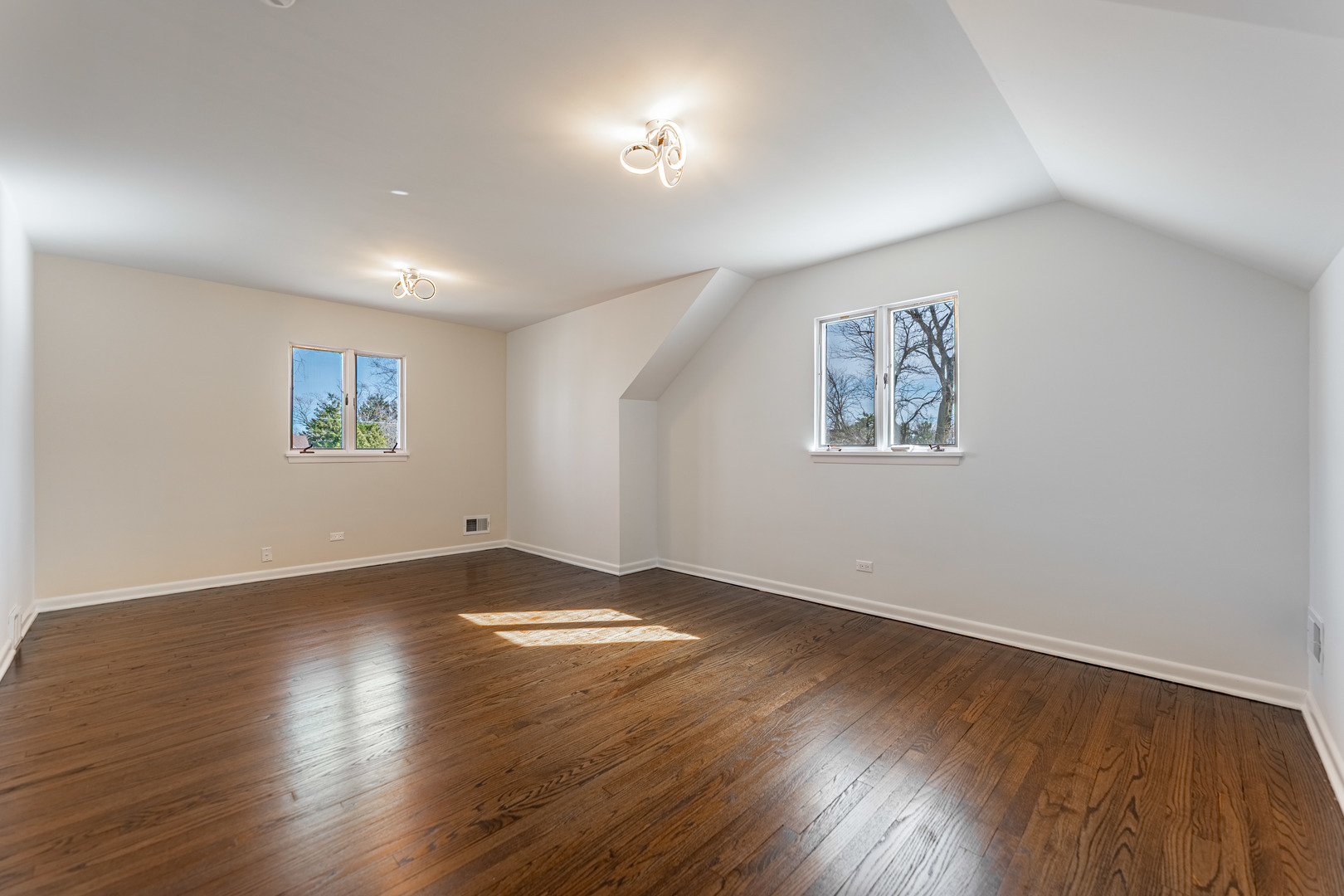 4313 Elm Avenue Lyons, IL 60534 - Photo 18 of 34 a view of an empty room with wooden floor and a window