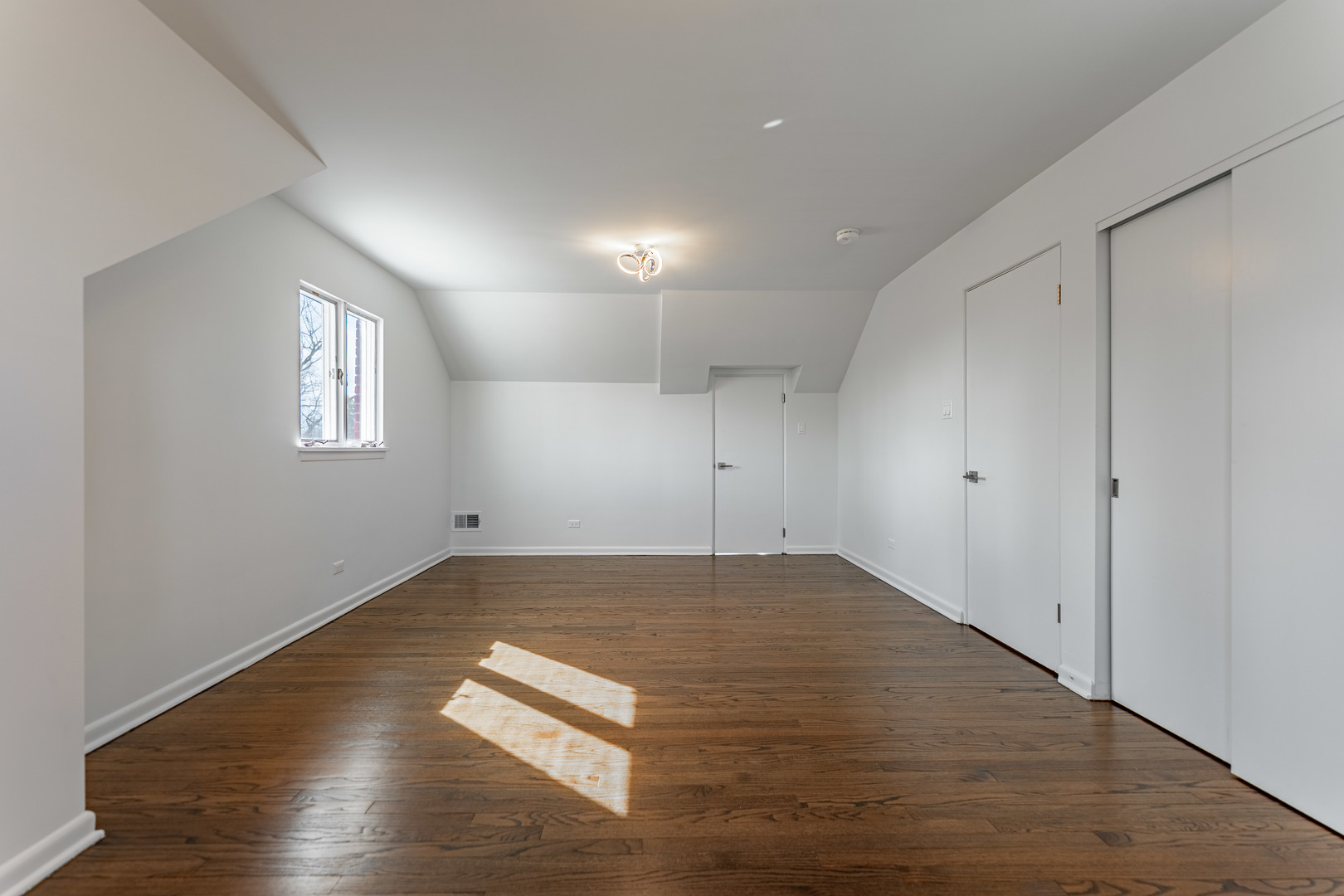 4313 Elm Avenue Lyons, IL 60534 - Photo 19 of 34 an empty room with wooden floor and windows