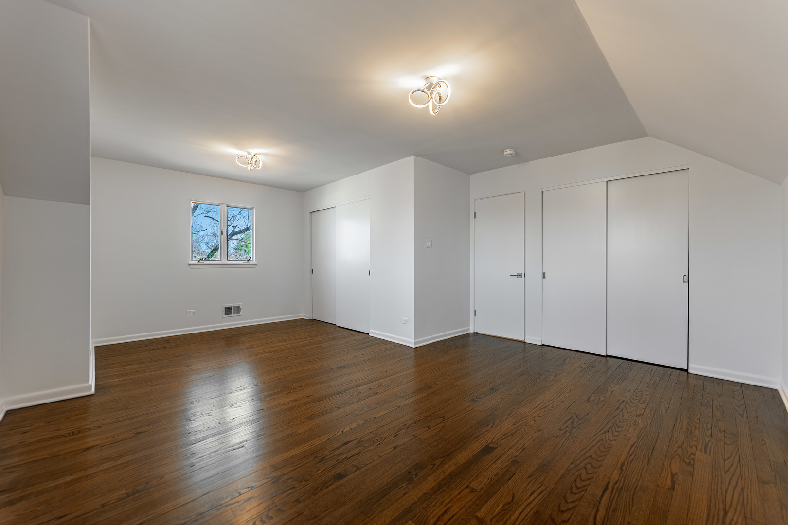 4313 Elm Avenue Lyons, IL 60534 - Photo 23 of 34 an empty room with wooden floor and windows