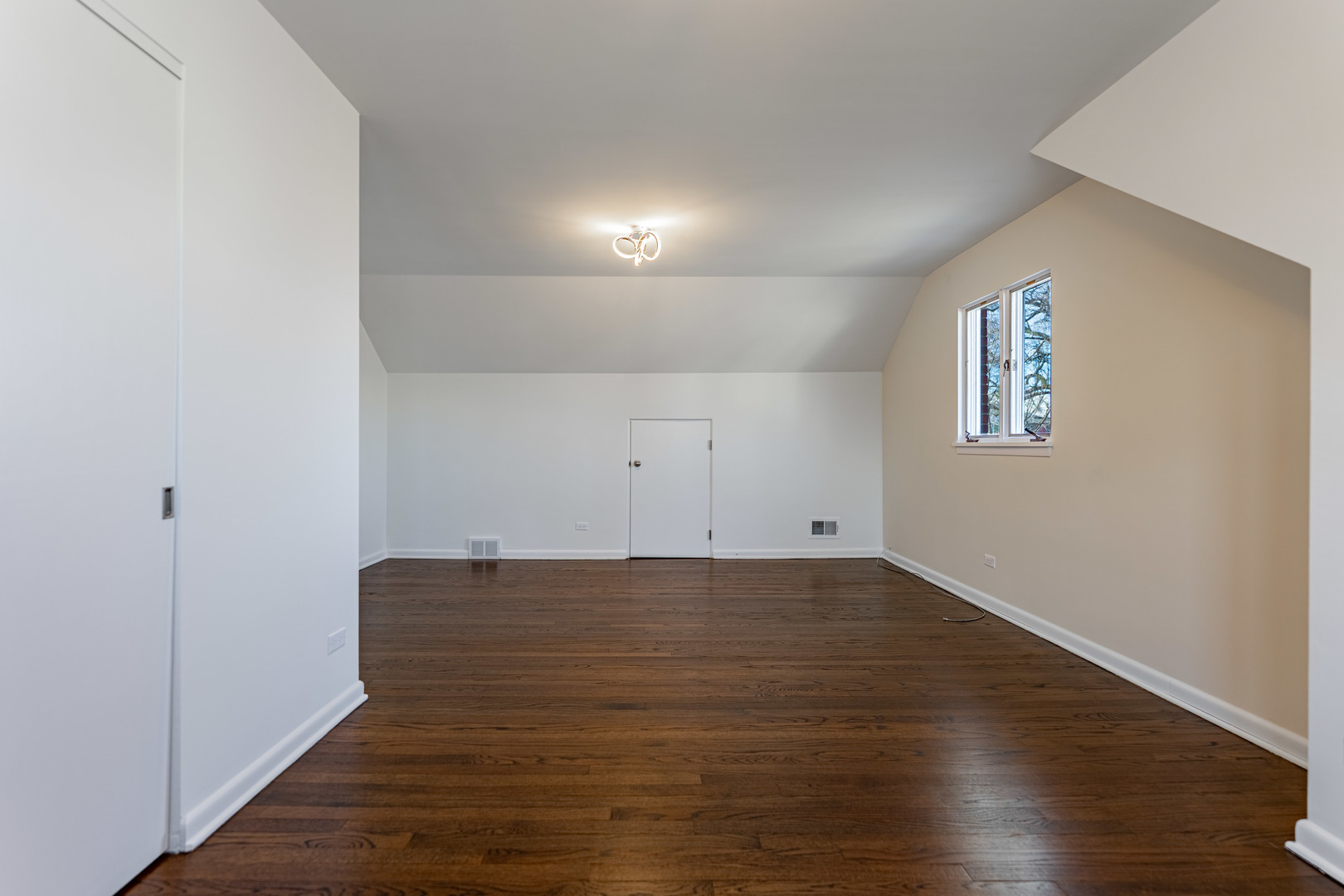 4313 Elm Avenue Lyons, IL 60534 - Photo 24 of 34 an empty room with wooden floor and windows