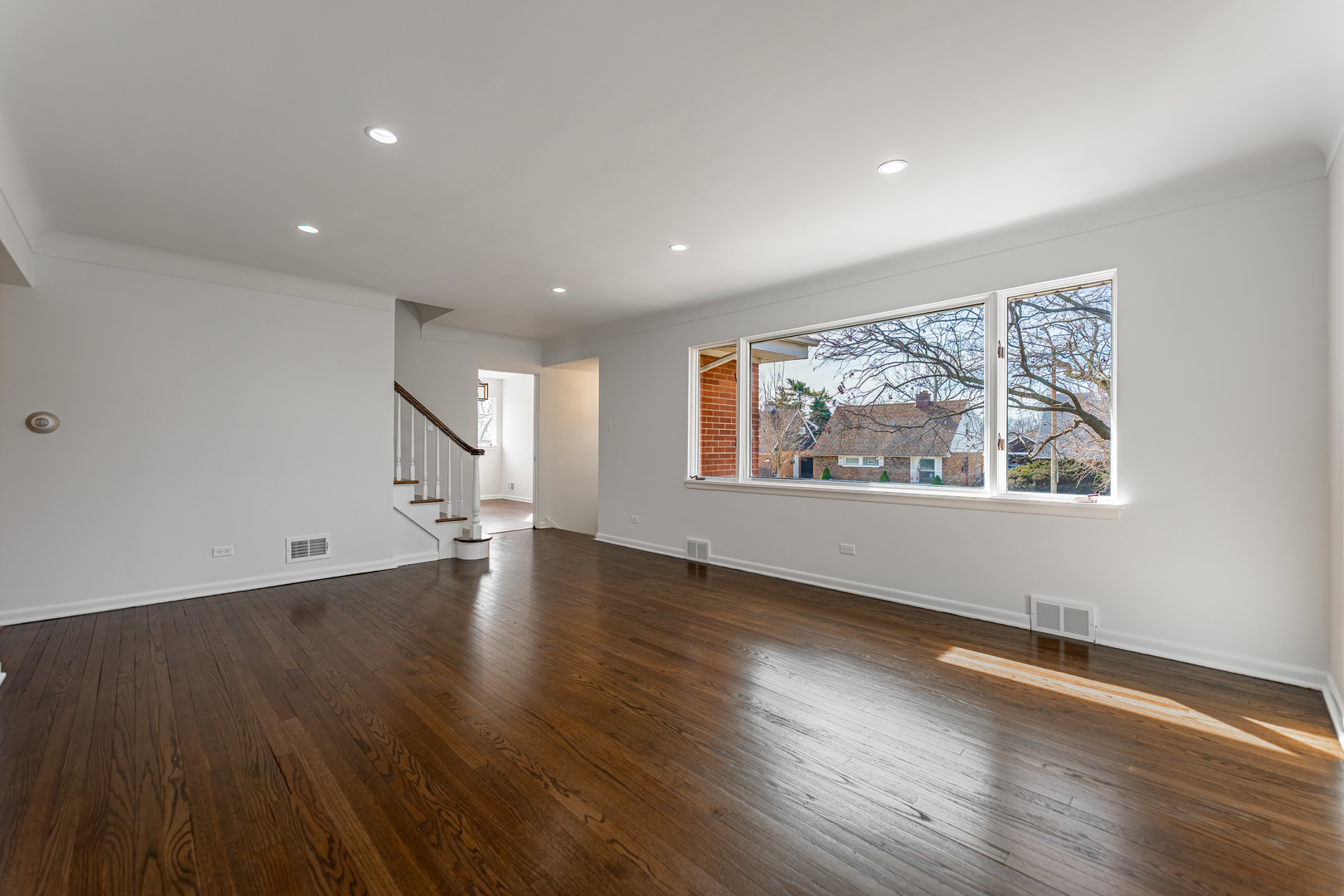 4313 Elm Avenue Lyons, IL 60534 - Photo 5 of 34 a view of an empty room with wooden floor and a window