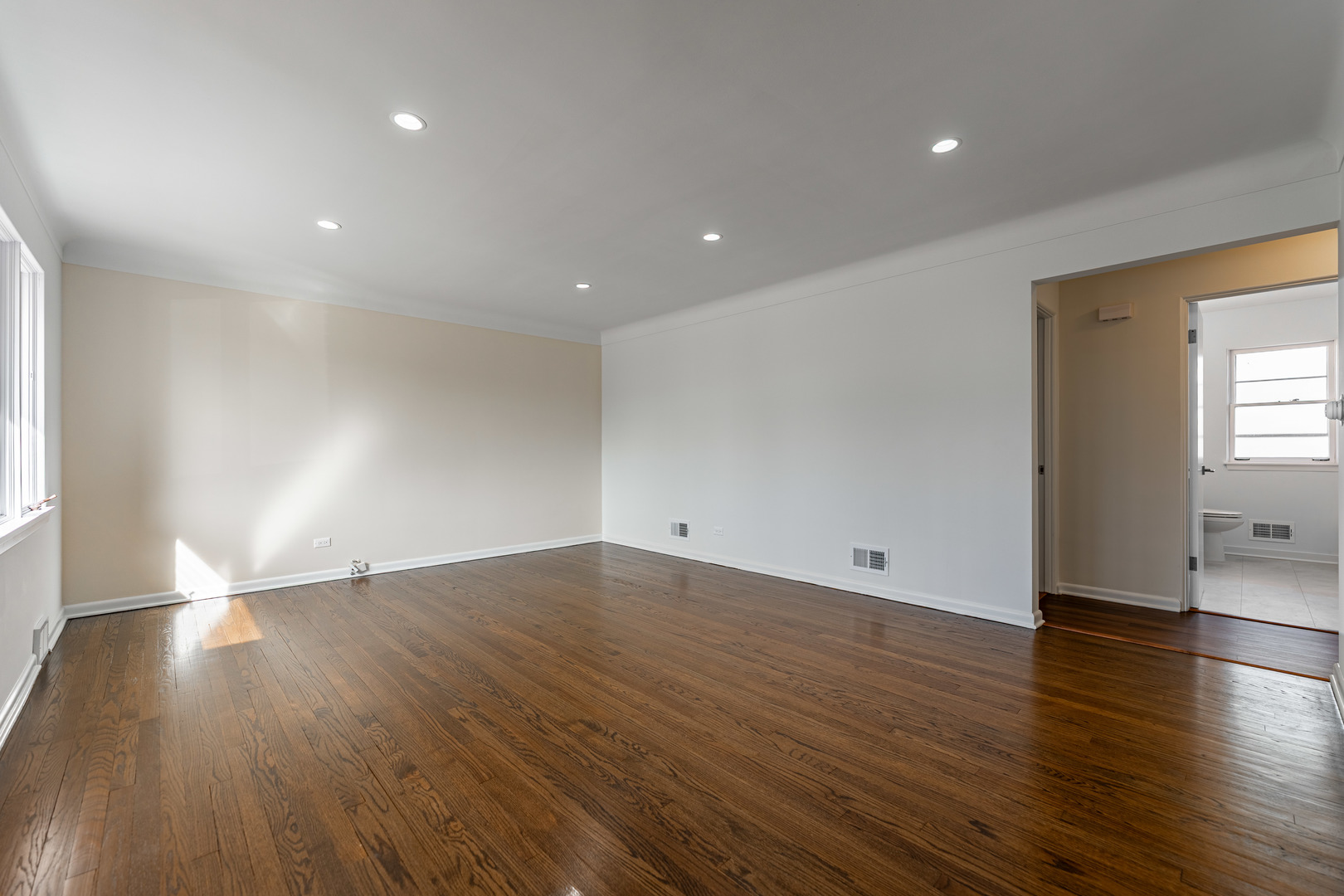 4313 Elm Avenue Lyons, IL 60534 - Photo 6 of 34 an empty room with wooden floor and windows