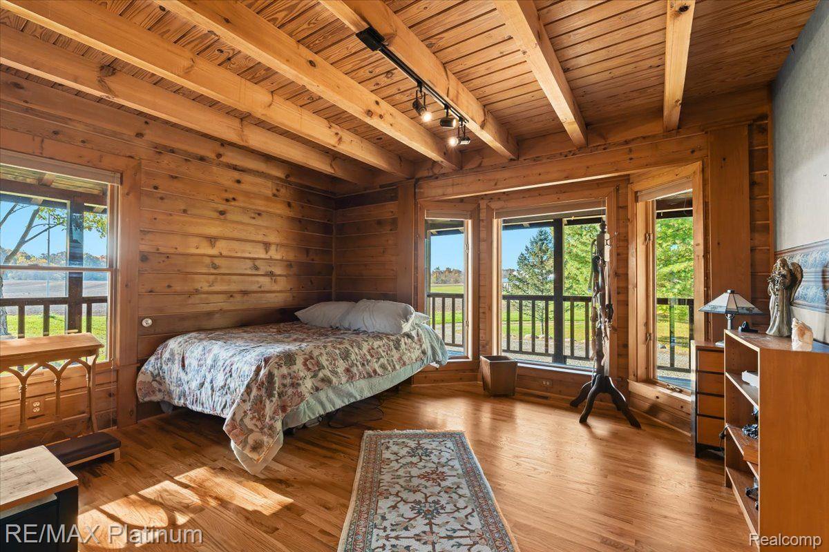 1215 South Bull Run Road Fowlerville, MI 48836 - Photo 27 of 80 Bedroom #2 on Main Level w/ Wood Surround/Floors.