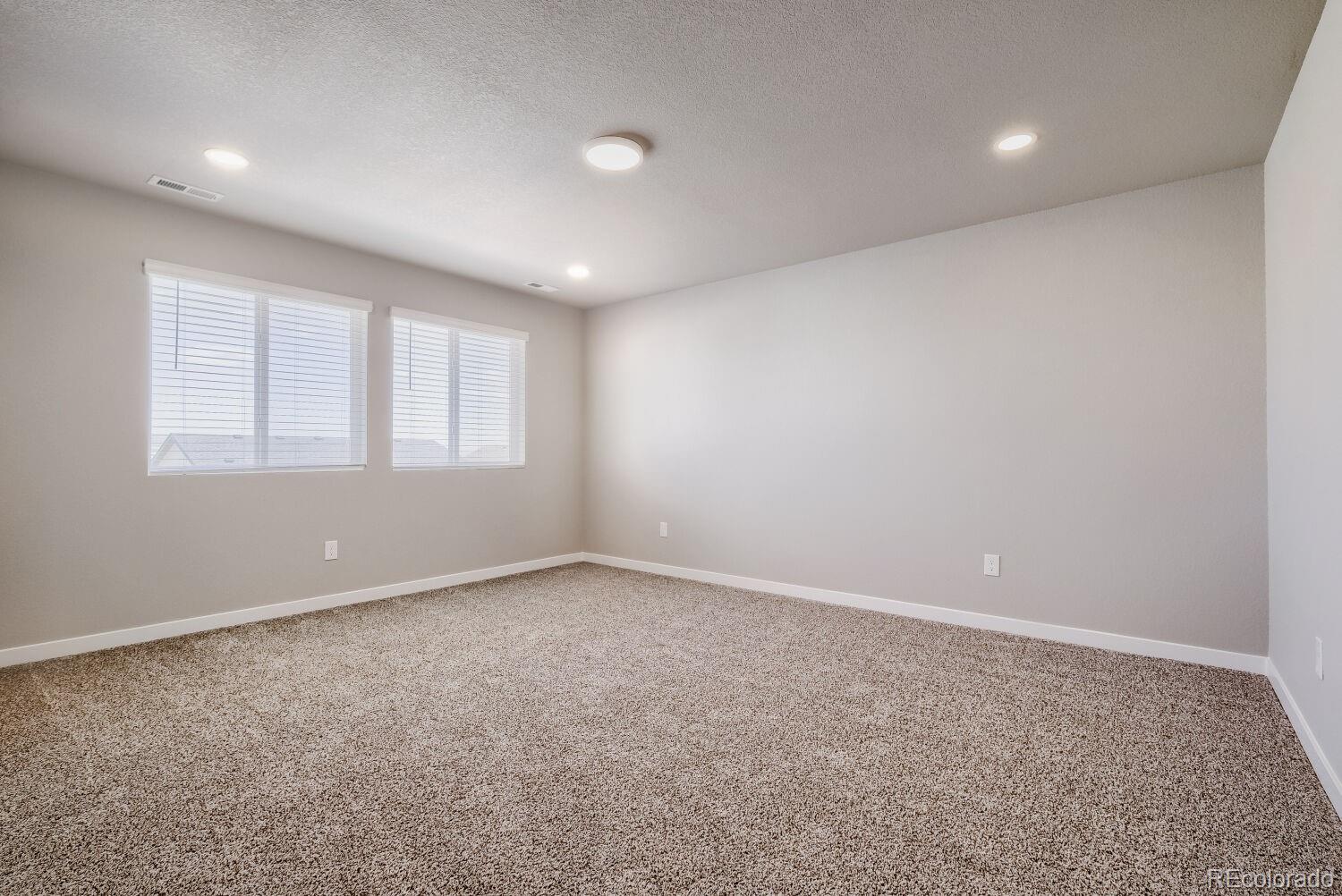 471 Atchison Way Calhan, CO 80808 - Photo 6 of 31 an empty room with windows