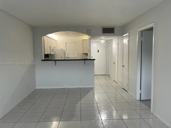 a view of a kitchen with a sink and cabinets