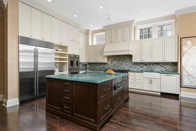 a kitchen with stainless steel appliances granite countertop a stove a sink and a refrigerator