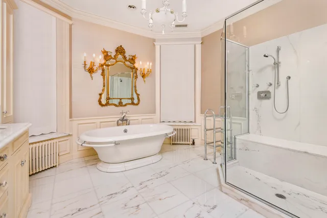 a bathroom with a tub sink and mirror