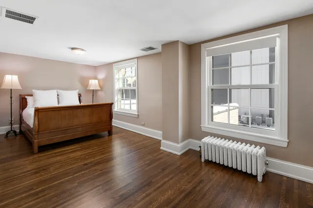 a living room with a bed furniture and a window