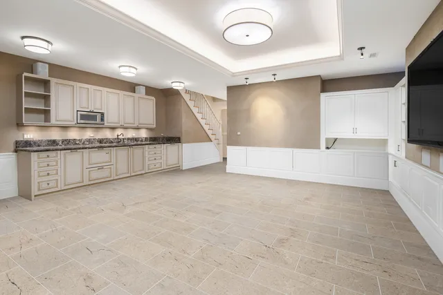 a large white kitchen with a large window