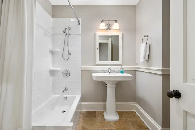 a bathroom with a sink a mirror and shower
