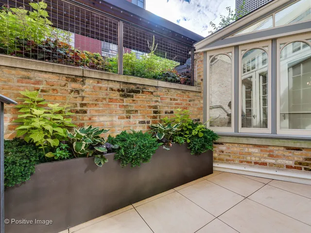 a potted plant sitting in front of a brick building