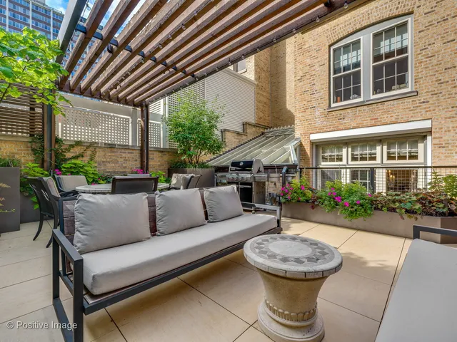a view of a patio with couches and potted plants