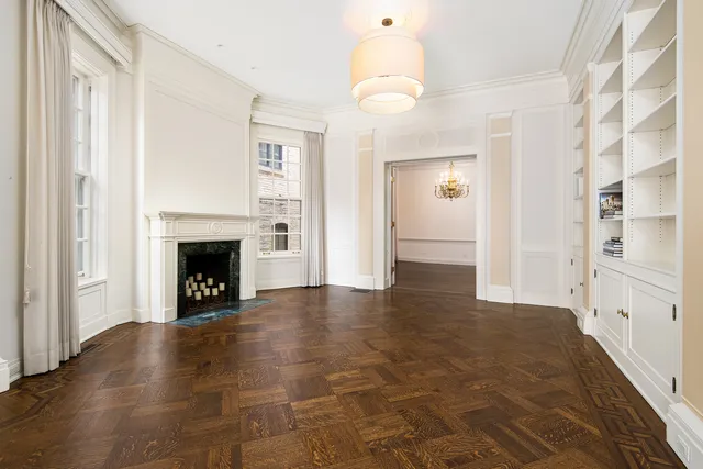 a view of an empty room with a fireplace