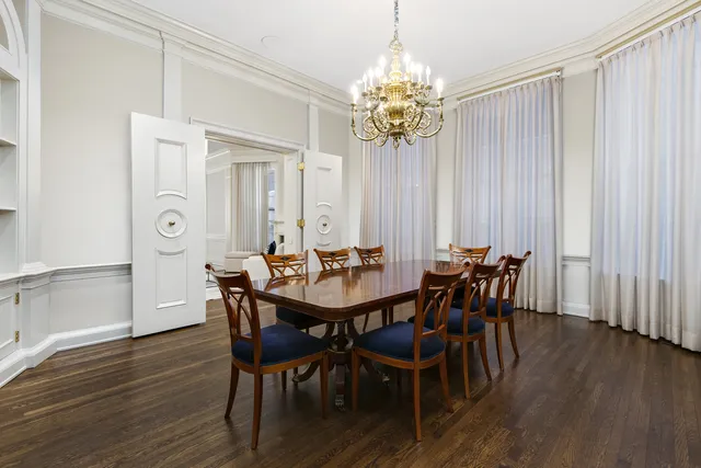 a view of a dining room with furniture and chandelier