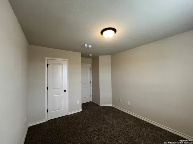 an empty room with closet area
