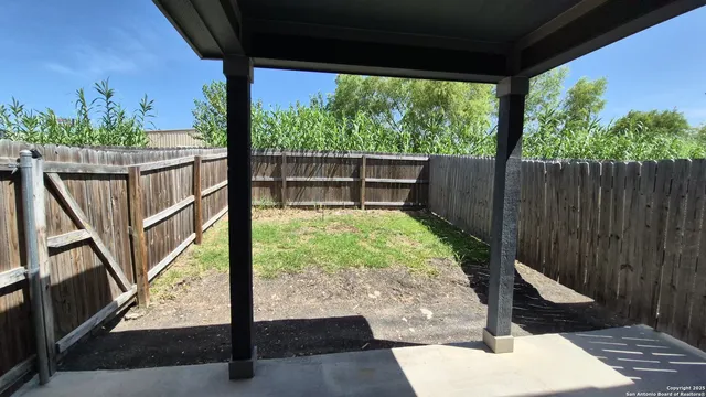 a view of a deck with wooden floor and a potted plant
