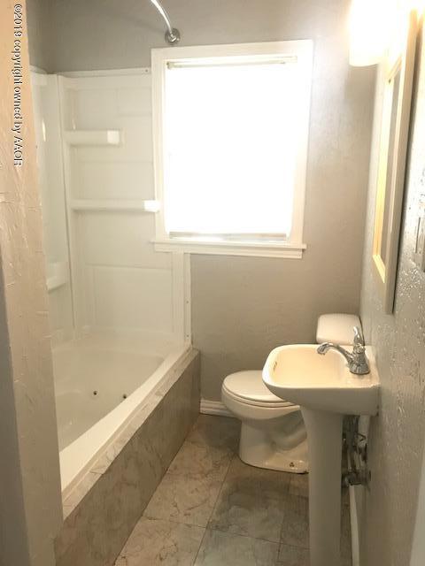 4110 South Lipscomb Street Amarillo, TX 79110 - Photo 12 of 13 a bathroom with a sink toilet and shower