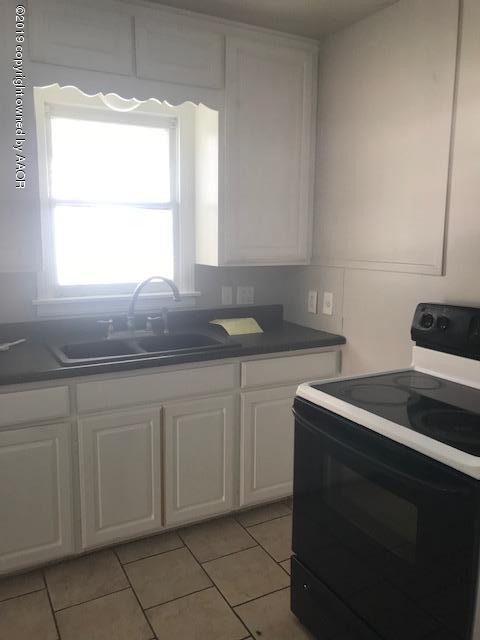 4110 South Lipscomb Street Amarillo, TX 79110 - Photo 5 of 13 a kitchen with granite countertop white cabinets and a sink