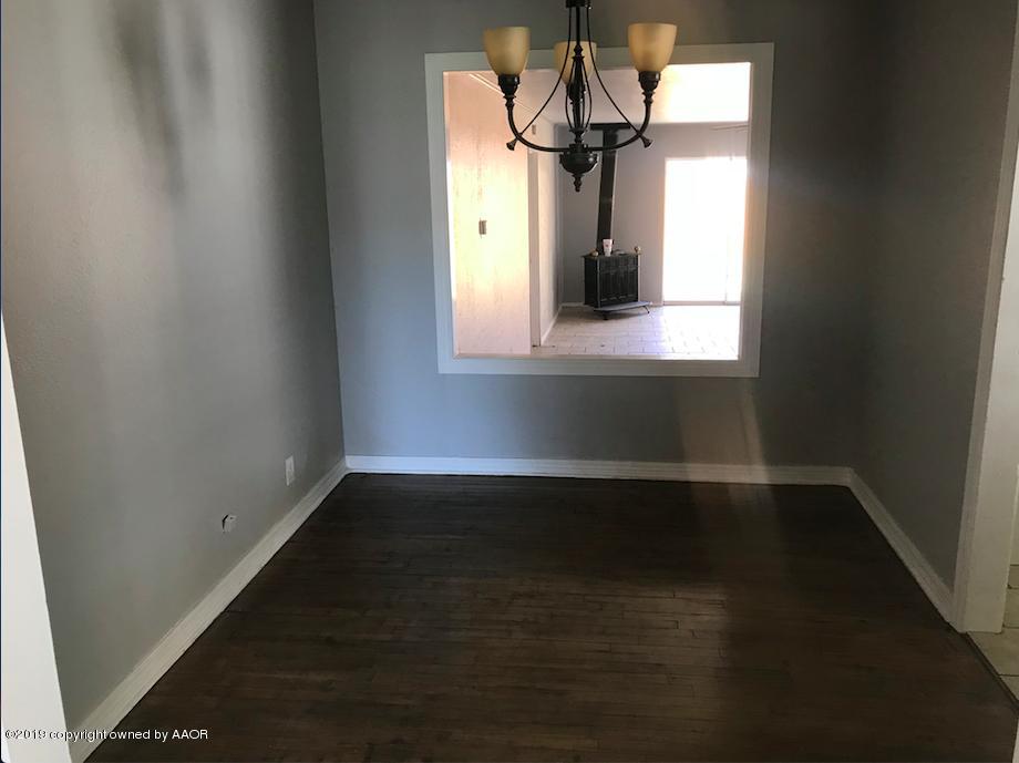 4110 South Lipscomb Street Amarillo, TX 79110 - Photo 6 of 13 a view of wooden floor and a chandelier in a room
