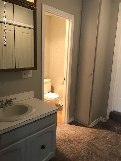 4110 South Lipscomb Street Amarillo, TX 79110 - Photo 10 of 13 a bathroom with a sink a toilet and a mirror