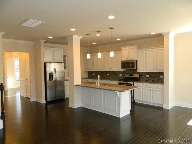 729 Falcon Ridge, Unit HKC109 Fort Mill, SC 29708 - Photo 3 of 12 a kitchen with stainless steel appliances granite countertop a refrigerator a stove a sink and a microwave