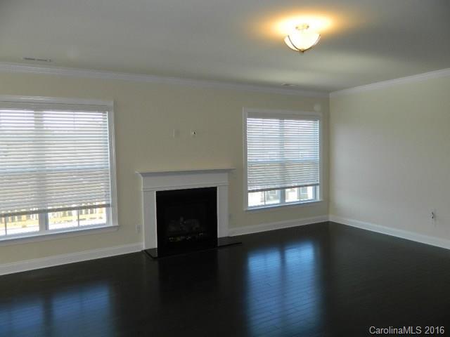 729 Falcon Ridge, Unit HKC109 Fort Mill, SC 29708 - Photo 6 of 12 an empty room with wooden floor and windows