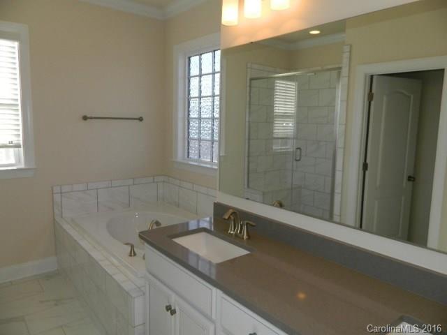 729 Falcon Ridge, Unit HKC109 Fort Mill, SC 29708 - Photo 9 of 12 a bathroom with a sink a shower and a bathtub