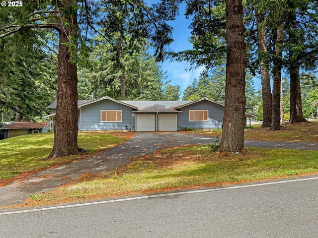 a view of a house with a tree beside of it
