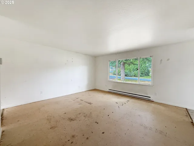 a view of a room with racks on the wall and a shower