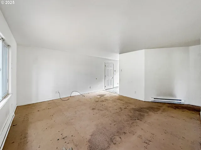 a kitchen with a white stove refrigerator and cabinets