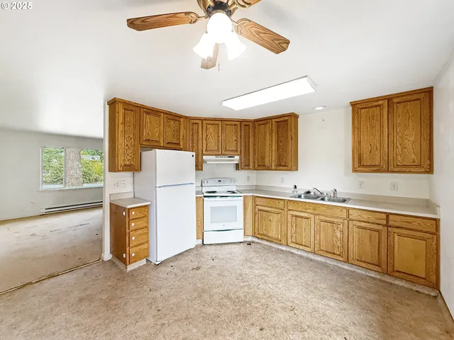 a kitchen with a stove a refrigerator and a microwave