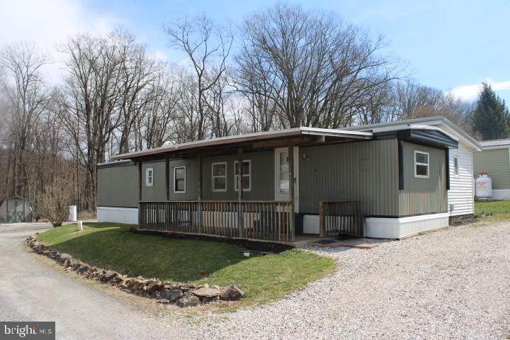 450 Ridge Road, Unit 8 Etters, PA 17319 - Photo 1 of 1 a front view of a house with a garden and trees