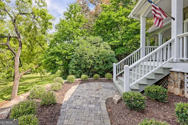 a living room with furniture a chandelier and a fireplace