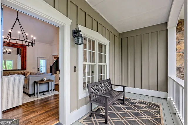 a view of a balcony with furniture and a yard