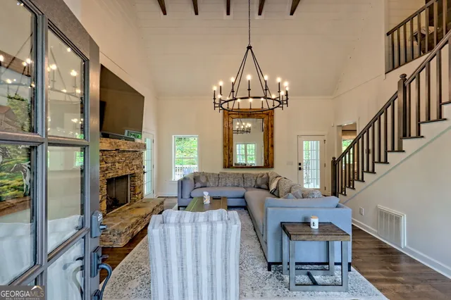 a living room with furniture and a chandelier
