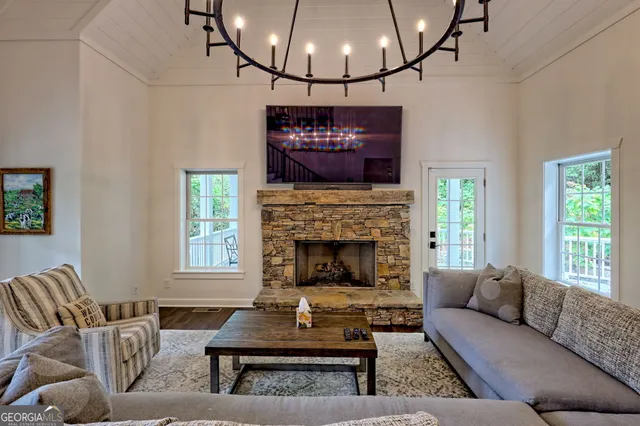 a view of a dining room with furniture a chandelier and wooden floor