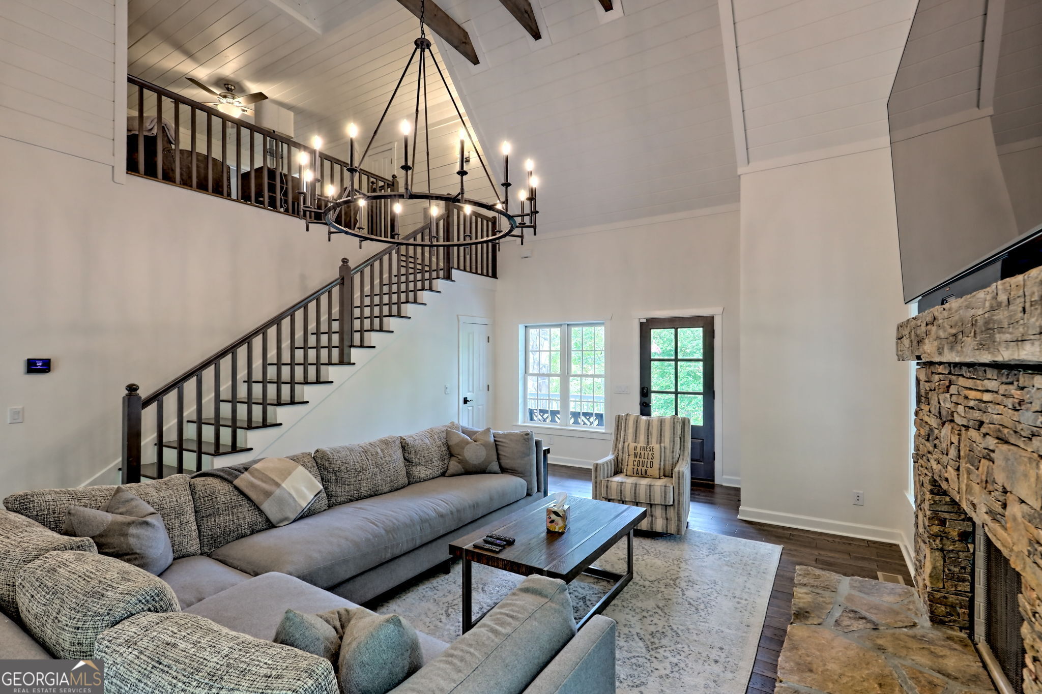 571 Ledford Road Dillard, GA 30537 - Photo 20 of 78 a living room with furniture a fireplace and a chandelier