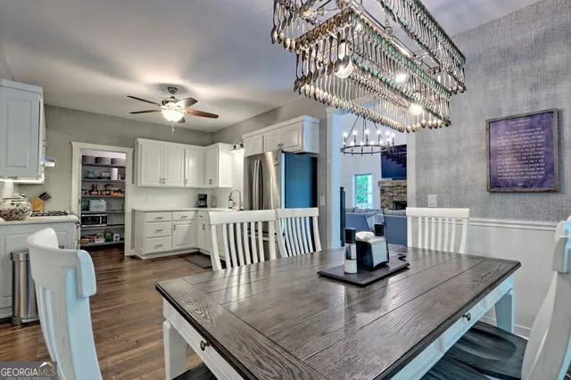 a living room with furniture two window and a potted plant