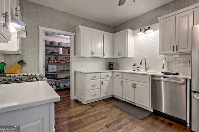 a living room with furniture chandelier and a fireplace