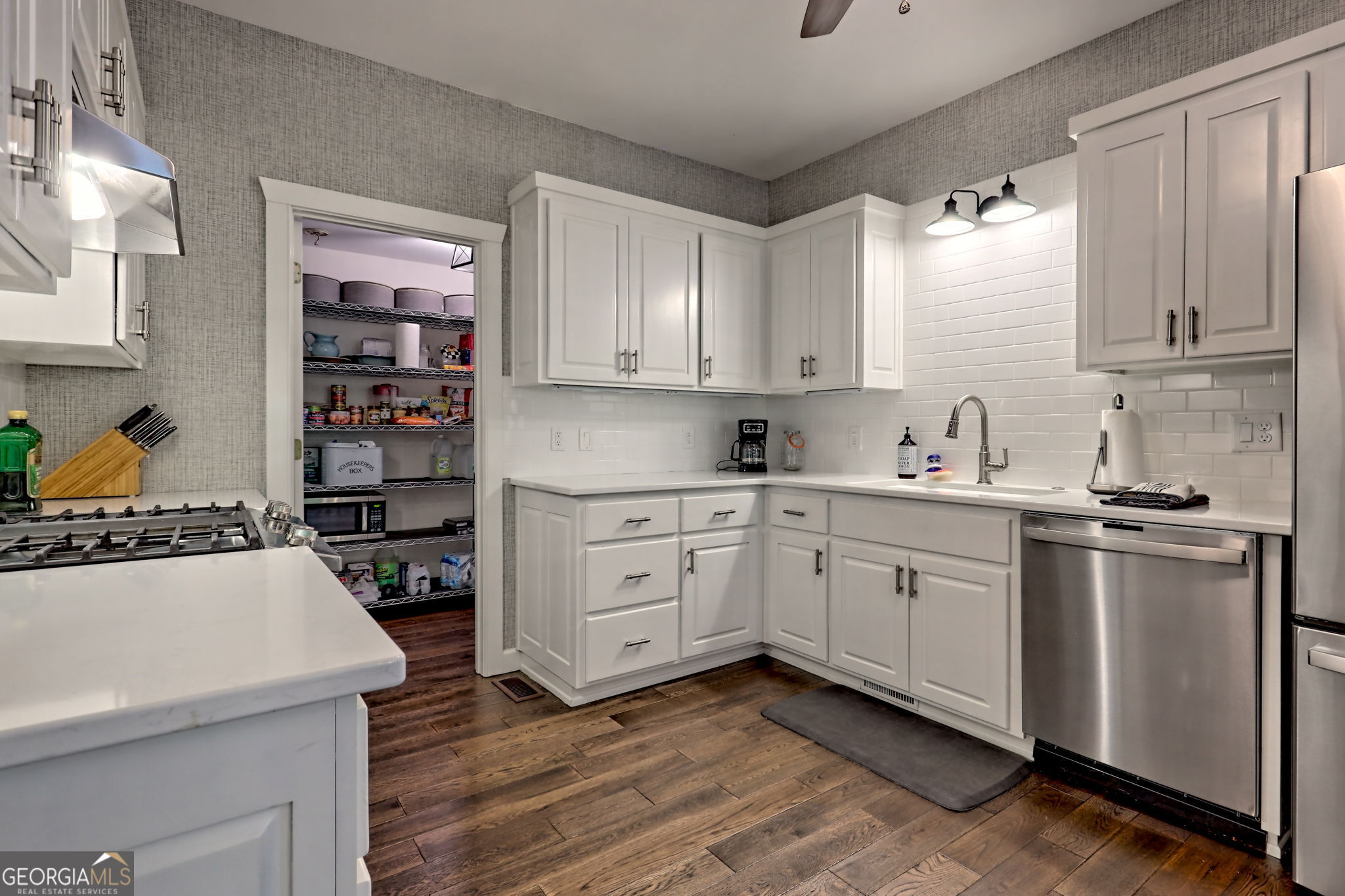 571 Ledford Road Dillard, GA 30537 - Photo 32 of 78 a kitchen with a stove a sink and a refrigerator