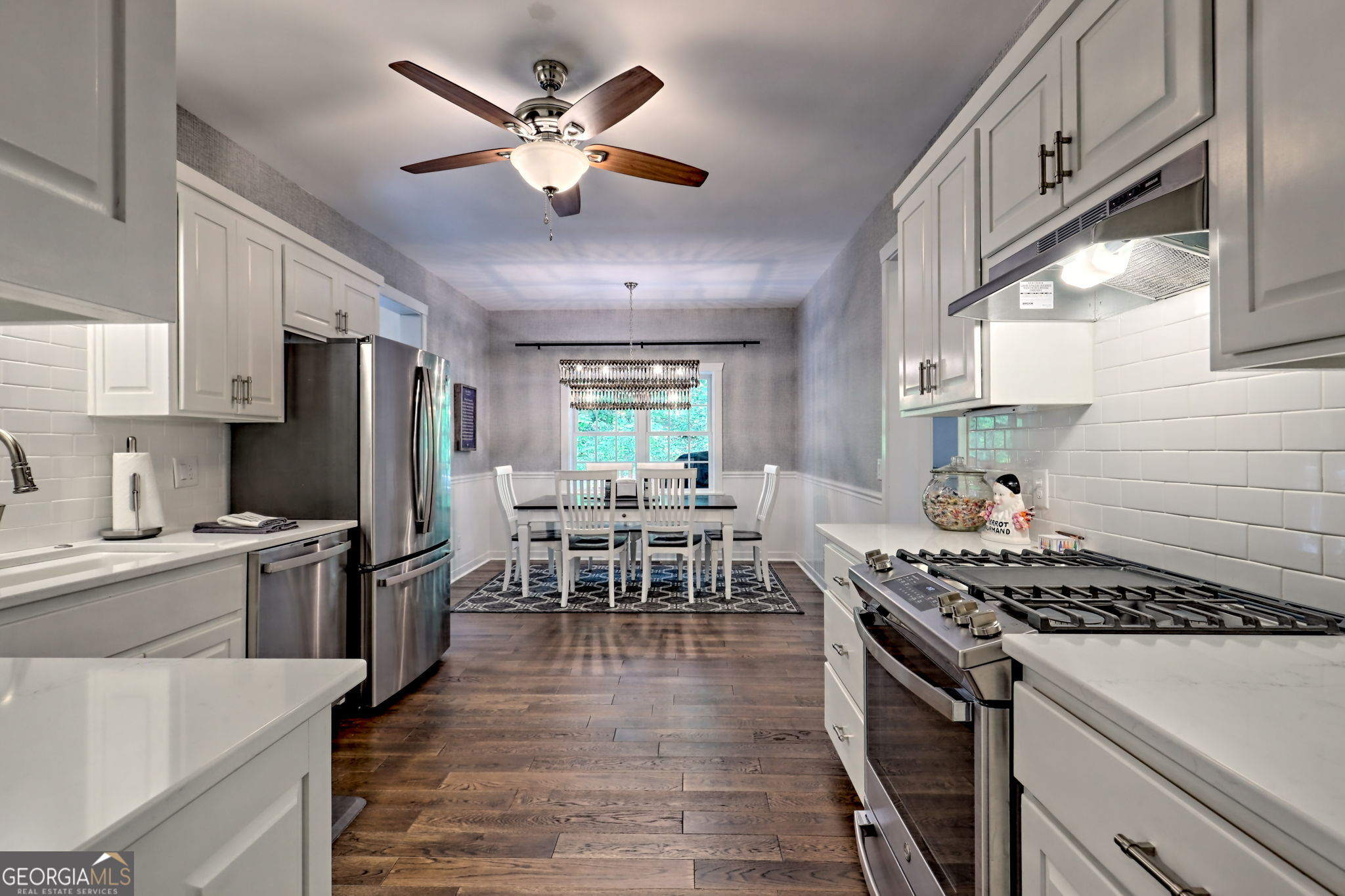 571 Ledford Road Dillard, GA 30537 - Photo 34 of 78 a kitchen with stainless steel appliances a stove a refrigerator a sink dishwasher a dining table and chairs with wooden floor