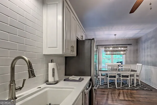 a spacious bedroom with a bed a window and a flat screen tv