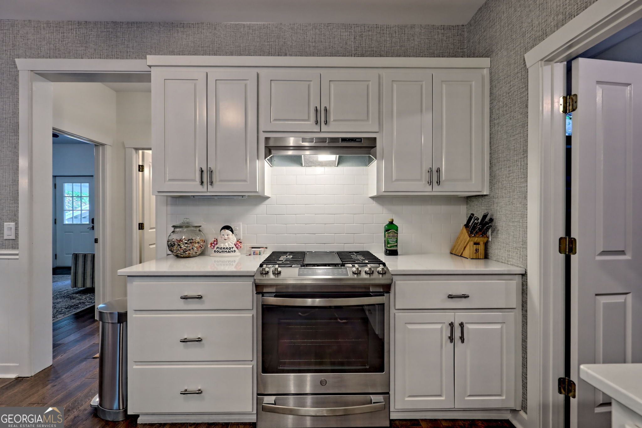 571 Ledford Road Dillard, GA 30537 - Photo 36 of 78 a kitchen with granite countertop white cabinets and white appliances